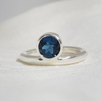 Sterling silver ring with off set London blue topaz